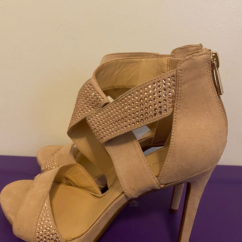 Tan suede open heels with tose gold rhinestone embelishments. They are a size 9.